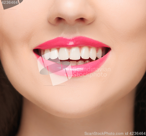 Image of The sensual red lips, mouth open, white teeth.
