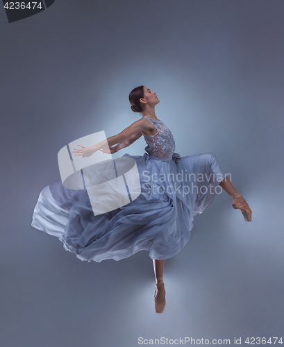 Image of The beautiful ballerina dancing in blue long dress 