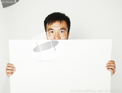 Image of pretty cool asian man holding empty white plate smiling