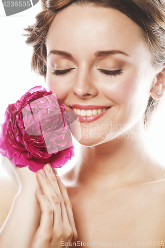 Image of young beauty woman with flower peony pink closeup makeup soft te