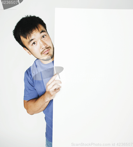 Image of pretty cool asian man holding empty white plate smiling