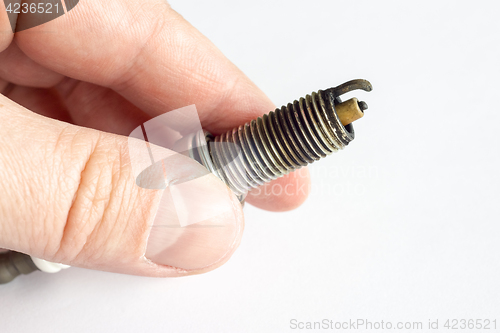 Image of Broken spark plug in hand
