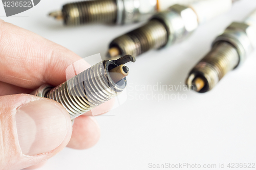 Image of Replacing damaged spark plugs for cars