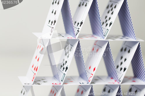 Image of house of playing cards over white background