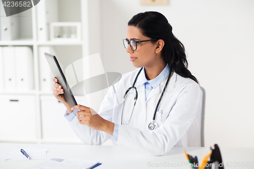 Image of doctor with tablet pc and clipboard at hospital