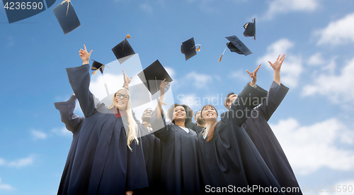 Image of happy students throwing mortar boards up