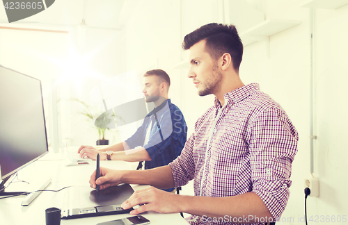 Image of man or designer with computer and tablet at office