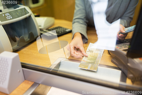 Image of clerk counting cash money at bank office