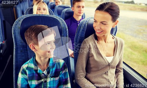 Image of happy family riding in travel bus