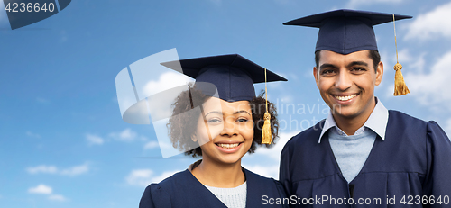 Image of students or bachelors in mortar boards over sky