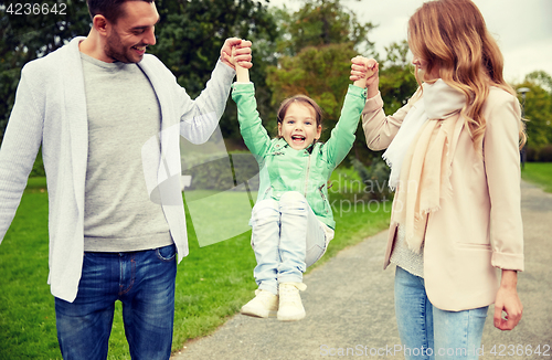 Image of happy family walking in summer park and having fun