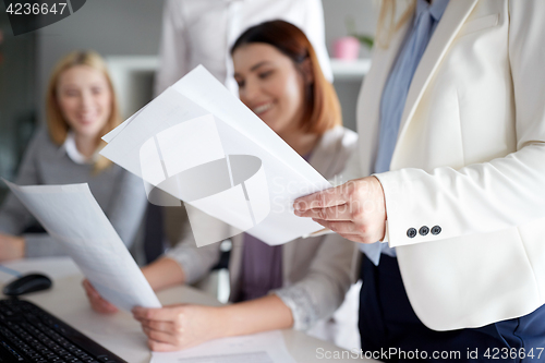 Image of businesswomen with papers in office