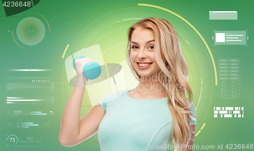 Image of smiling beautiful young sporty woman with dumbbell