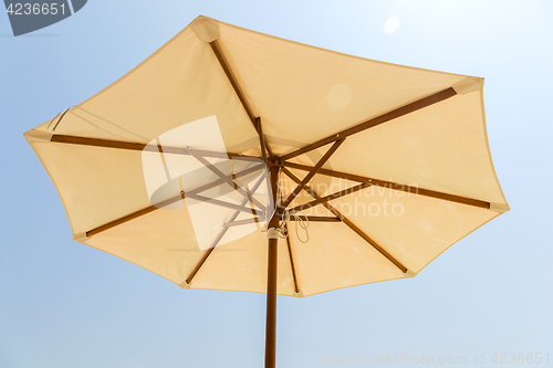 Image of parasol over blue sky