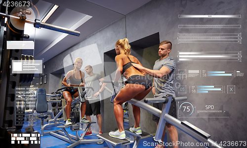 Image of man and woman flexing muscles on gym machine