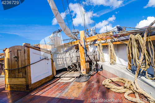 Image of The ship\'s bell and the anchor lift mechanism on the sailboat