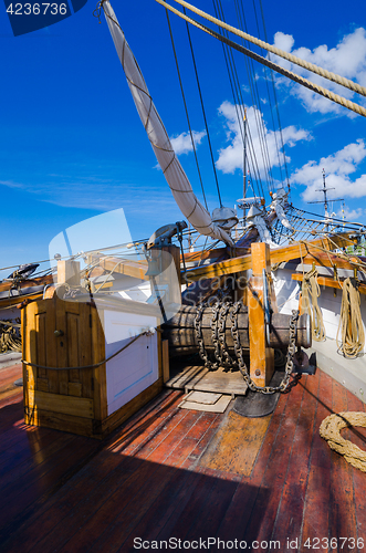 Image of The ship\'s bell and the anchor lift mechanism on the sailboat