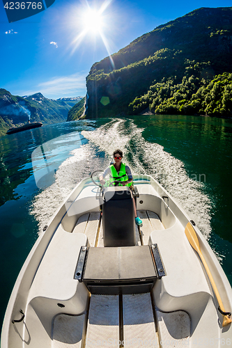 Image of Woman driving a motor boat