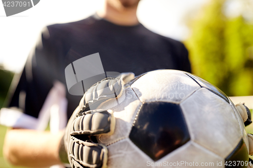 Image of close up of goalkeeper with ball playing football