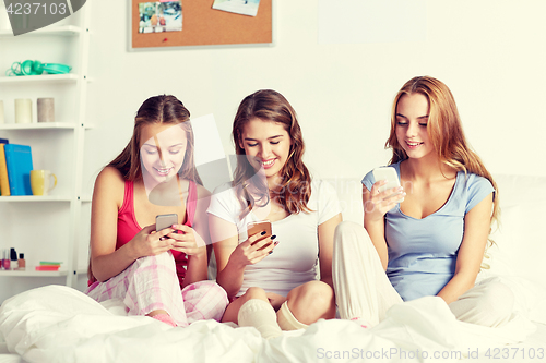 Image of friends or teen girls with smartphone at home