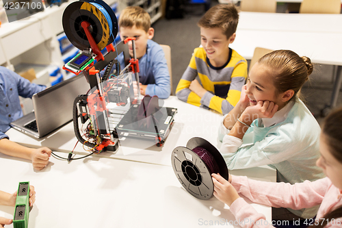 Image of happy children with 3d printer at robotics school