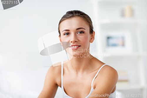 Image of beautiful happy young woman at home