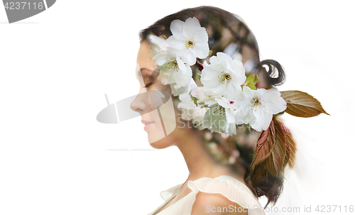 Image of beautiful young woman with cherry blossoms