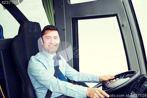 Image of happy driver driving intercity bus