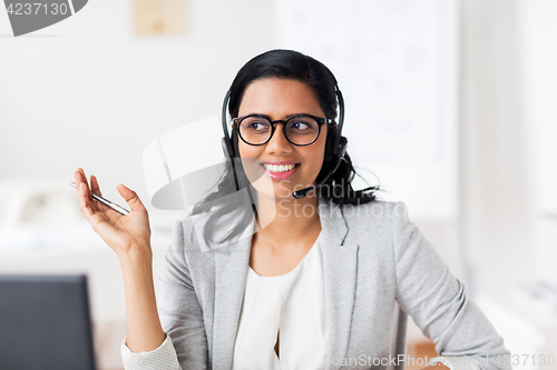 Image of businesswoman with headset talking at office