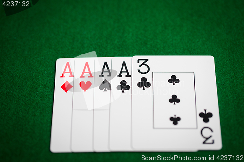 Image of poker hand of playing cards on green casino cloth