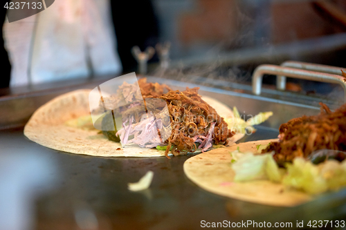 Image of tortilla wraps cooking at street market