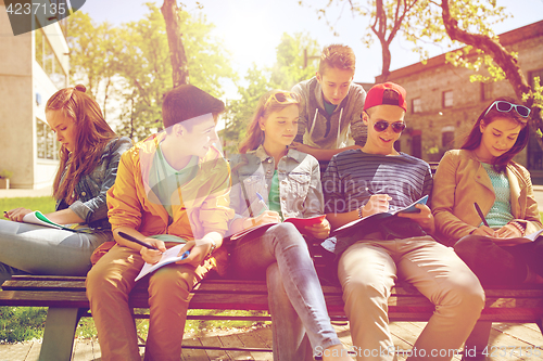 Image of group of students with notebooks at school yard