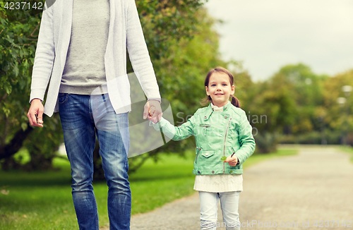 Image of close up of father and little girl walking in park