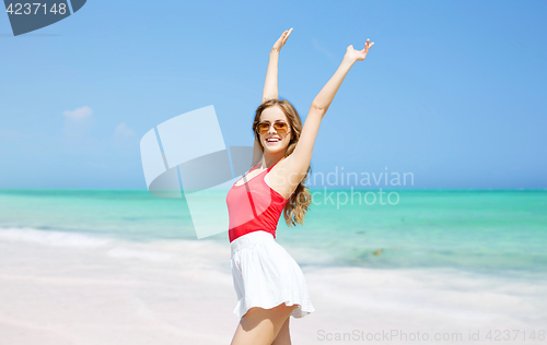Image of happy young woman in sunglasses on summer beach