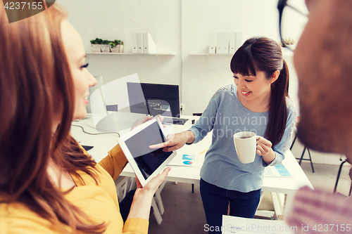 Image of creative team with tablet pc talking at office