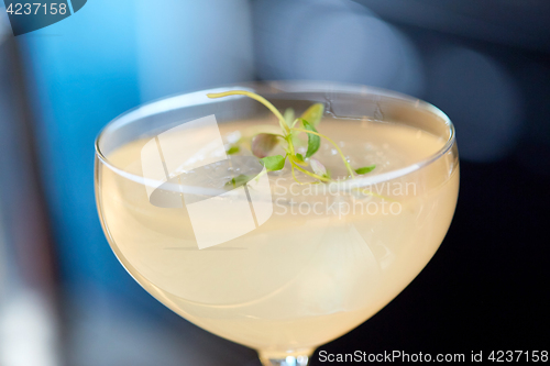 Image of close up of glass with cocktail at bar