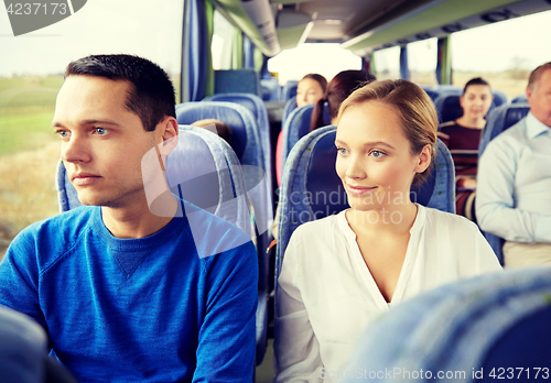 Image of happy couple or passengers in travel bus