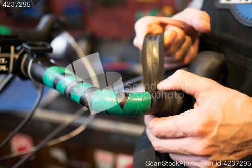 Image of Guy fixing helm of bicycle