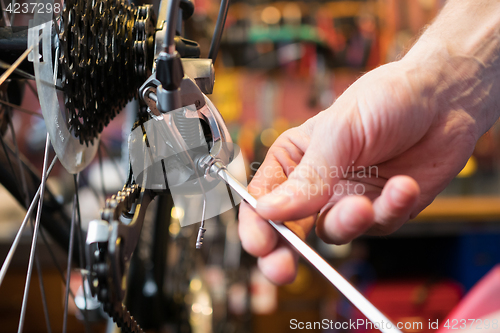 Image of Guy fixing bicycle in garage