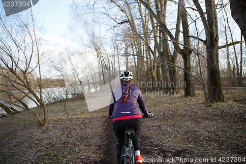 Image of Sportswoman rides bicycle at park