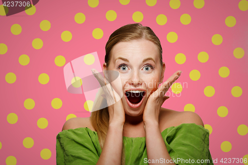 Image of Surprised woman in green sweater