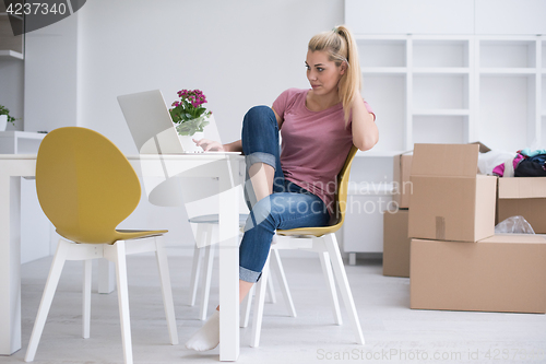 Image of Young woman moving in a new home