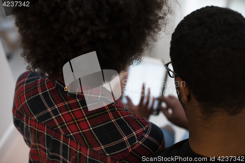 Image of african american couple using tablet at home