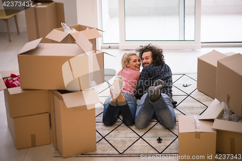 Image of Young couple moving in a new flat