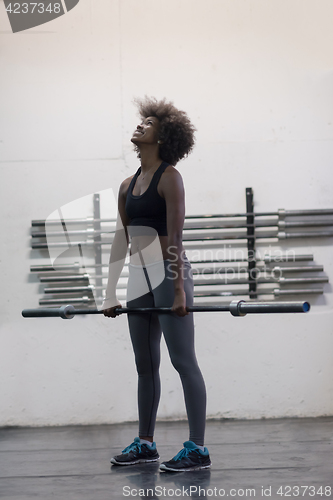 Image of black woman lifting empty bar