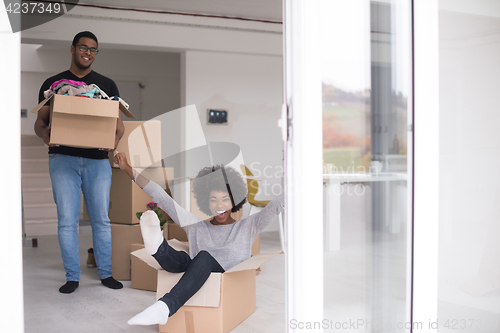 Image of African American couple  playing with packing material