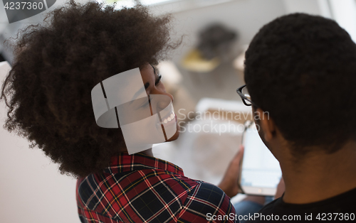 Image of african american couple using tablet at home