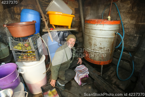 Image of Old man making brandy