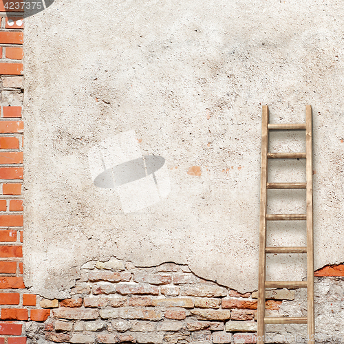 Image of weathered stucco wall with wooden ladder