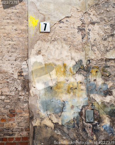 Image of colorful brick wall and plate with a number seven